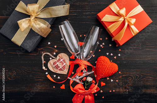 concept for valentine's day. gala dinner for two with two glasses of champagne. background with the attributes of the celebration of Valentine's Day. dominant red color. studio shot, top view. photo