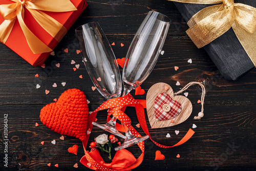 concept for valentine's day. gala dinner for two with two glasses of champagne. background with the attributes of the celebration of Valentine's Day. dominant red color. studio shot, top view. photo