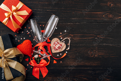 concept for valentine's day. gala dinner for two with two glasses of champagne. background with the attributes of the celebration of Valentine's Day. dominant red color. studio shot, top view. photo