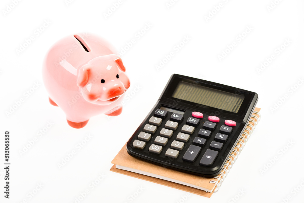 Piggy bank pink pig and calculator. Exchange rates. Economics and business administration. Credit debt concept. Piggy bank money savings. Economics and profit management. Economics and finance Piggy bank pink pig and calculator. Exchange rates. Economics and business administration. Credit debt concept. Piggy bank money savings. Economics and profit management. Economics and finance