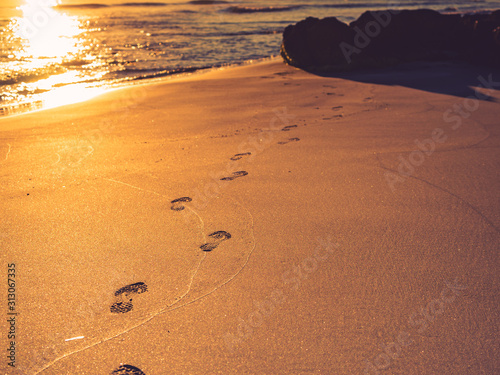 Sunset and footprints on beach