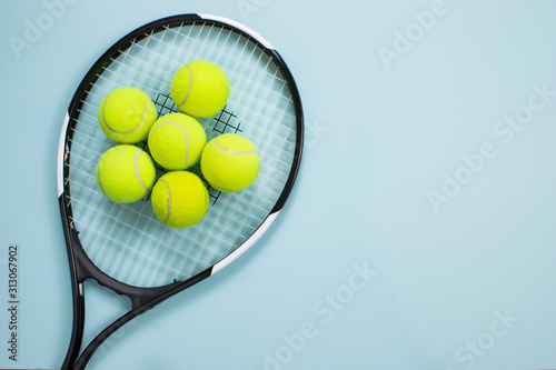 Tennis ball and racket isolated background. Top view © mertkantekin