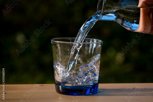 Pouring pure water in to the glass make spread of water crystal bubble with background nature
