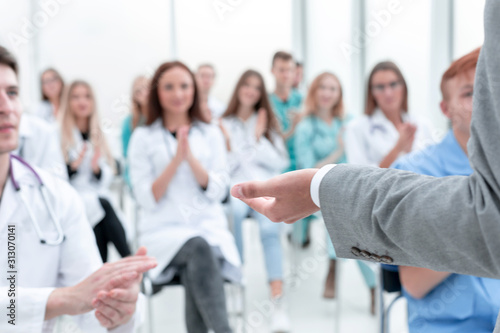 top view. a group of smiling doctors pointing at you.