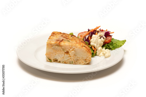 Close-up of a Spanish omelette with salad on an isolated white background