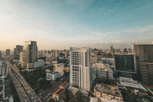 Wake Up, City. Bangkok bird's-eye view in the early morning. Asian big city sky line with visible air pollution and smog at dawn. Horizontal shot. Copy space in upper part © Adamov