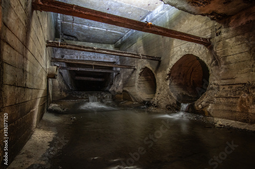 Big square rainwater drainage tunnel, with drain pipes.