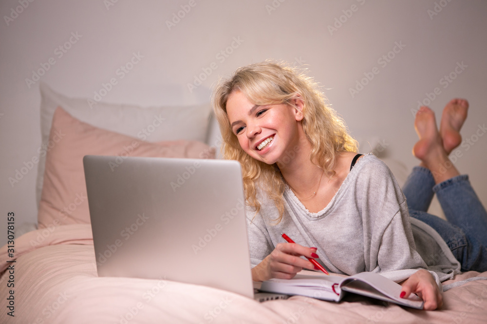 Smiling girl student study at home with laptop Smiling girl student study at home with laptop