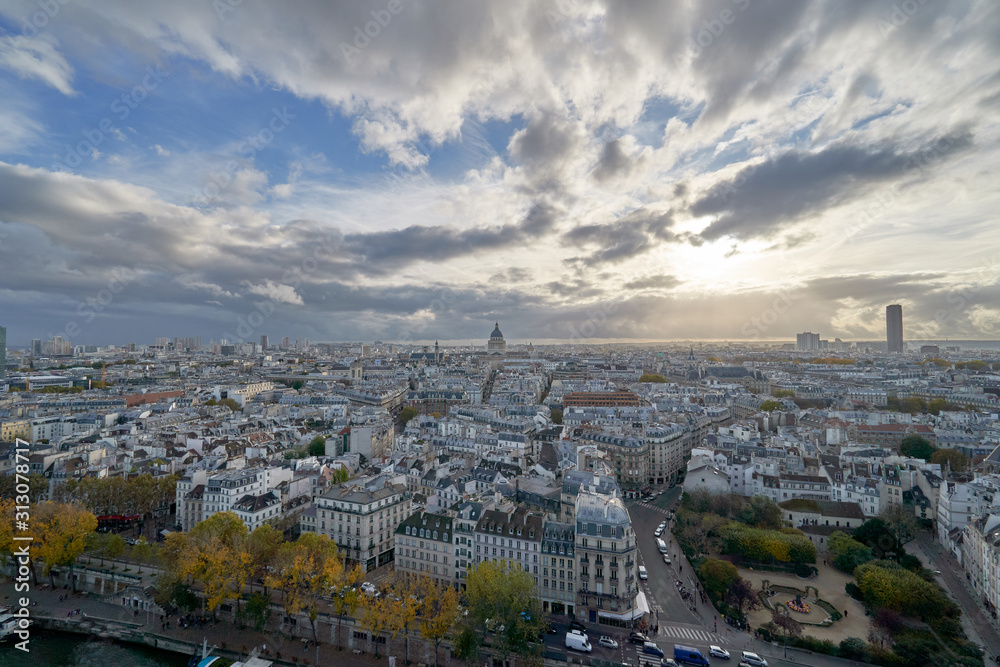 Aerial panorama of cityscape with a beautiful architecture of the Paris and with a cloudy sky over France.