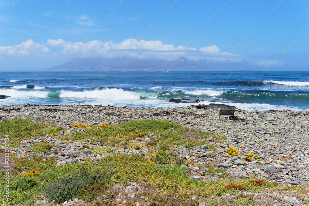 A distant Cape Town, viewed from the beach on Robben Island
