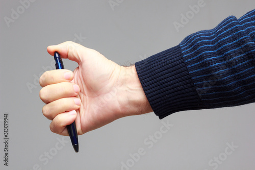 Pen in the hand of an adult
