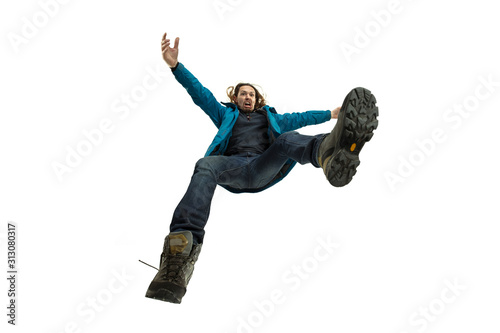 A second before falling. Caucasian young man falling down in moment with bright emotions and facial expression. Male model in casual clothes on white. Shocked, scared, screaming. Copyspace for ad. photo