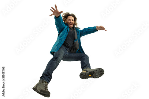 A second before falling. Caucasian young man falling down in moment with bright emotions and facial expression. Male model in casual clothes on white. Shocked, scared, screaming. Copyspace for ad. photo