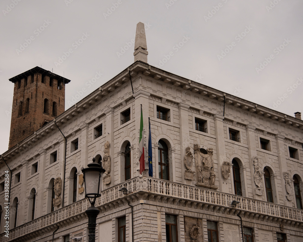 Palazzo Podestà seat of the Municipality of Padua in Piazza delle Erbe Padua, Italy. Of the thirteenth century, with flags of Italy and Europe with the monument to the Podestà and the coats of arms.