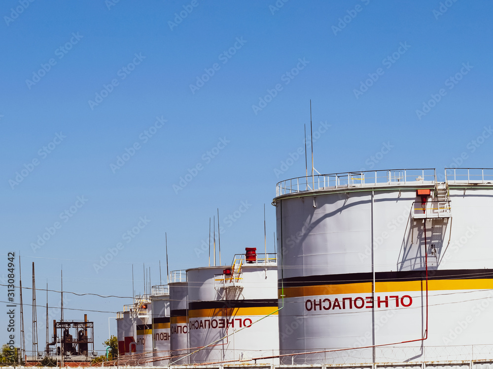 Fototapeta premium Tank the vertical steel. Capacities for storage of oil products. Caption: flammable.