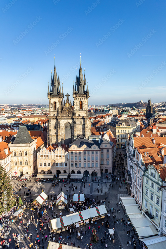 Old Town of Prague, Czech Republic. View on Tyn Church and Jan Hus Memorial on the square as seen from Old Town City Hall during Christmas market