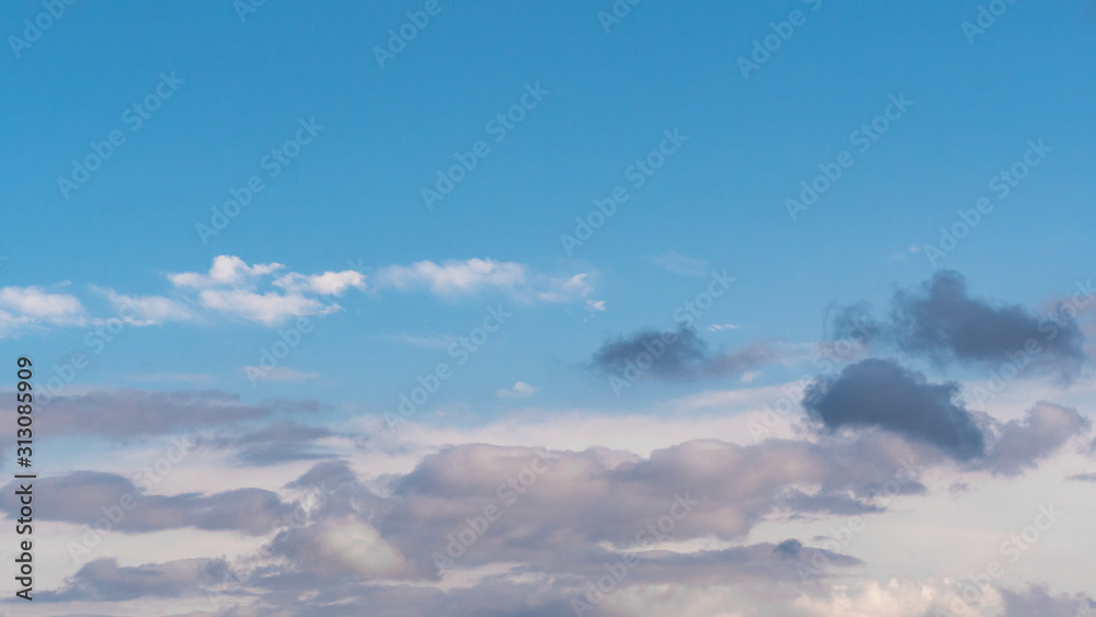 Clouds in the sky. Volumetric,cumulus and cirrostratus clouds in the daytime, blue sky. Dark, purple, thundercloud. Fast flying clouds. Unique cumulus.Landscape of sky and earthly atmosphere.Template