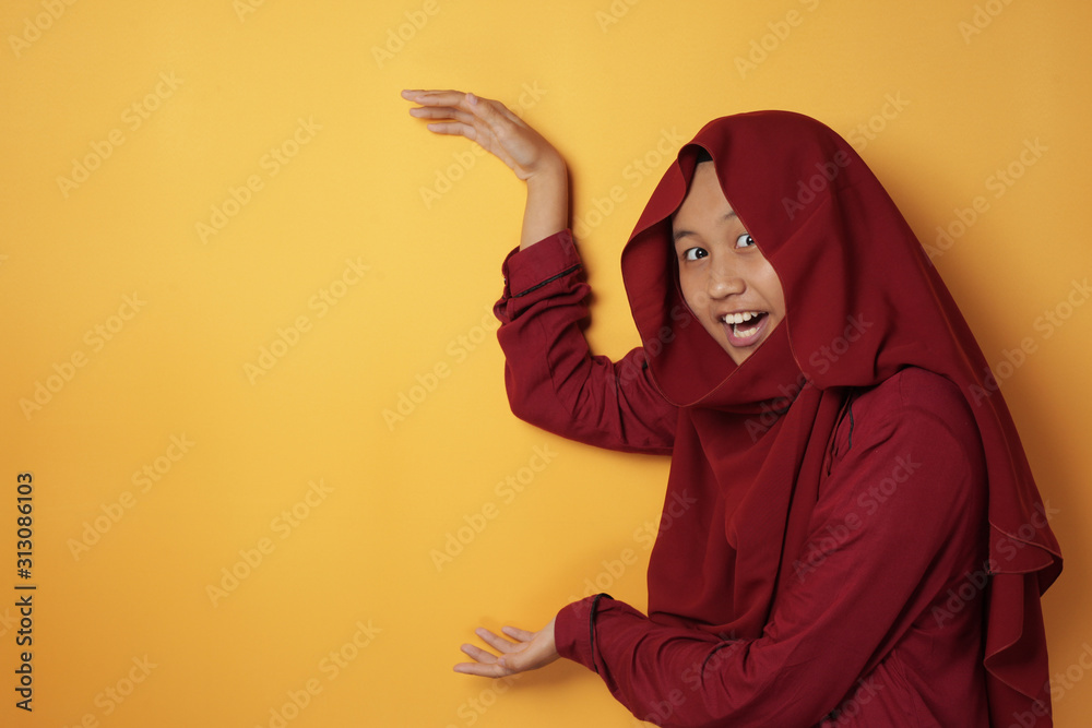 Asian Muslim Teenage Girl Wearing Hijab Shows Empty Copy Space Between Her Hands