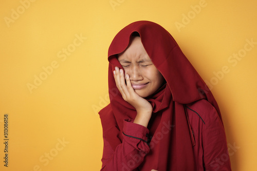 Asian Muslim Teenage Girl Wearing Hijab Suffer from Toothache © airdone