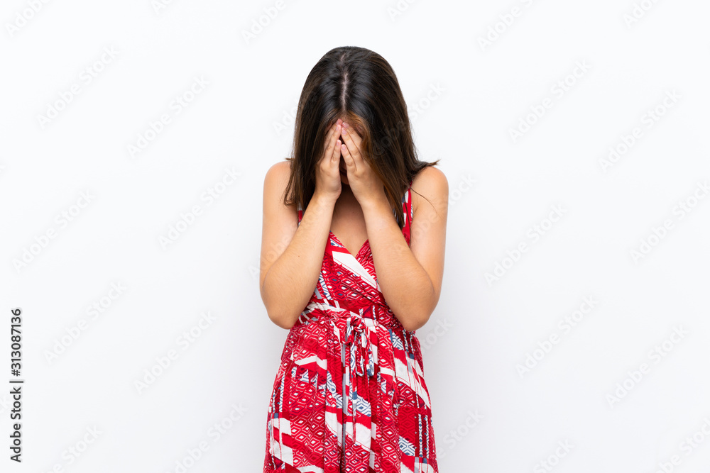 Caucasian girl in red dress over isolated white wall with tired and sick expression Caucasian girl in red dress over isolated white wall with tired and sick expression