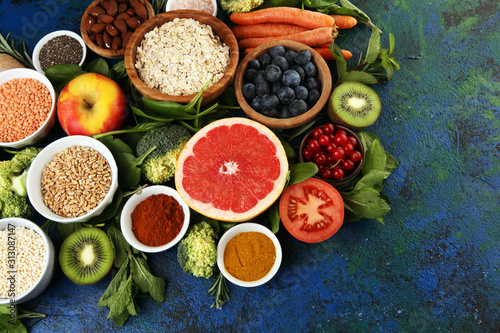 Healthy food clean eating selection  fruit  vegetable  seeds  superfood  cereals  leaf vegetable on rustic background