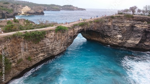Stone bridge, stone formation in the sea, blue ocean
