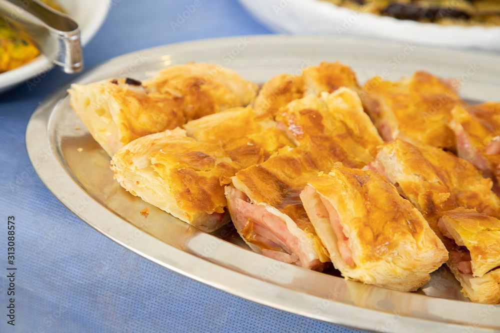 Breakfast buffet in hotel restaurant Pizza tray stuffed with mozzarella and ham