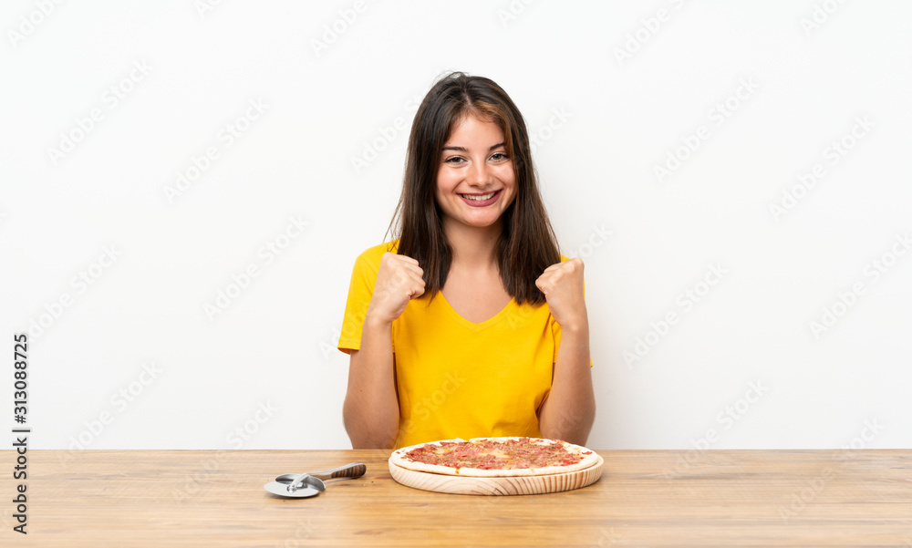 Caucasian girl with a pizza celebrating a victory Caucasian girl with a pizza celebrating a victory