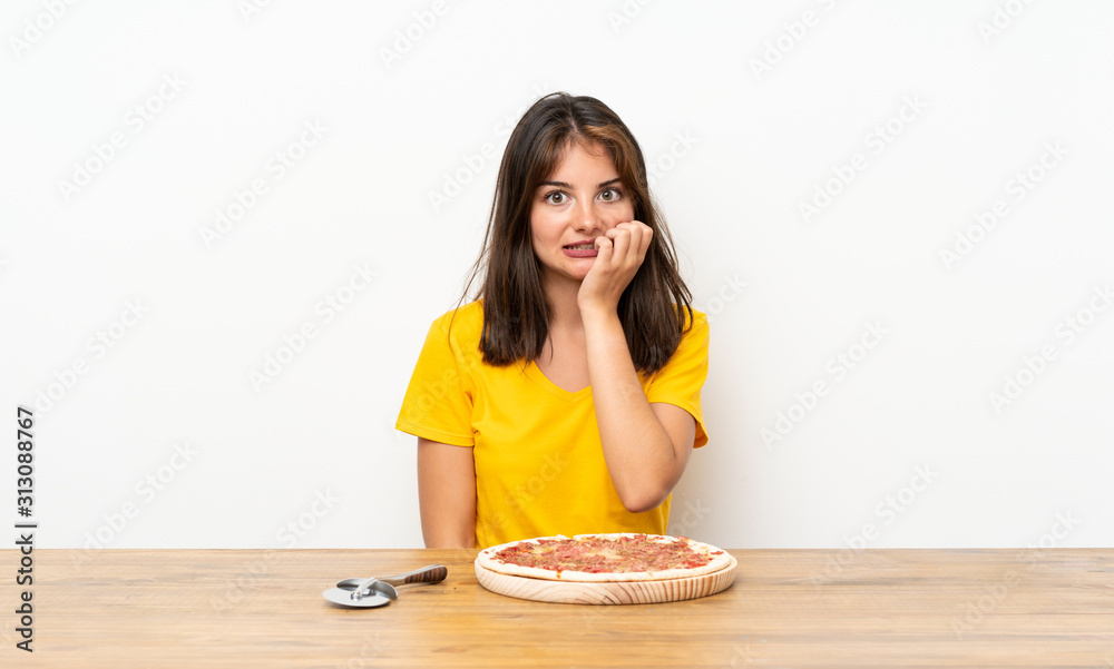 Caucasian girl with a pizza nervous and scared Caucasian girl with a pizza nervous and scared