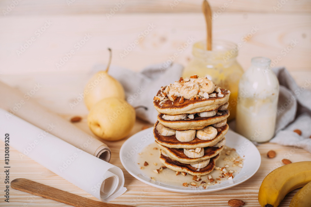 Stack of delicious pancakes with honey, nuts and slices of banana. Stack of delicious pancakes with honey, nuts and slices of banana.