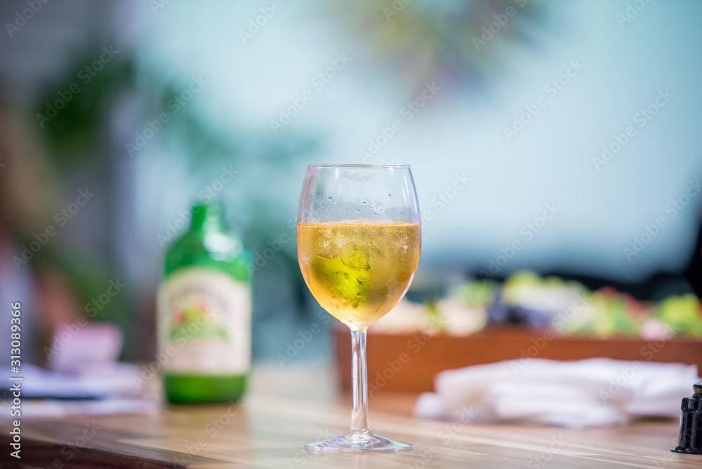 glass of white wine on wooden table