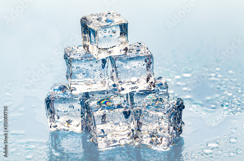 Square melting ice cubes on wet table