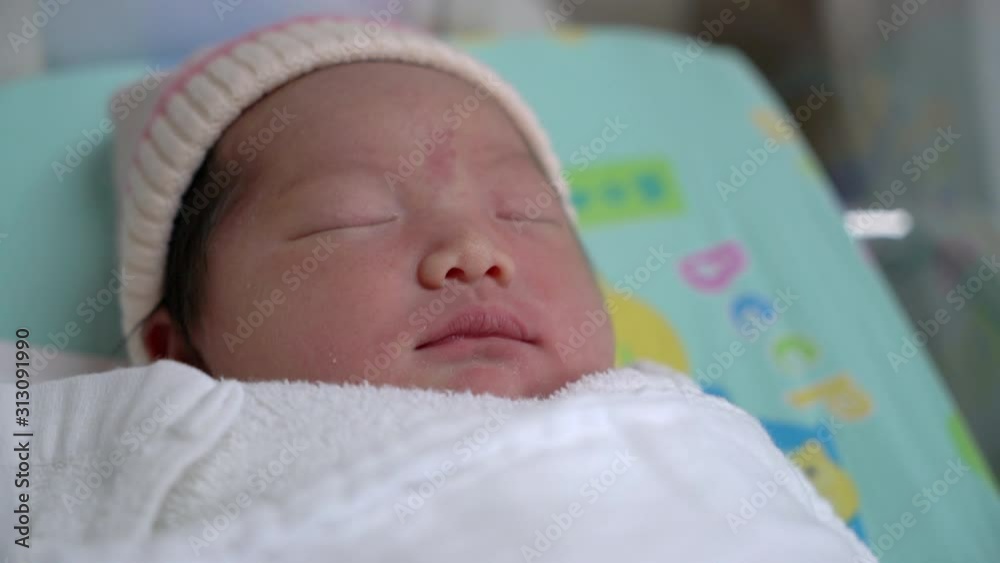 Close-up portrait of sleeping asian newborn baby, 4K handheld shot. Real live Close-up portrait of sleeping asian newborn baby, 4K handheld shot. Real live