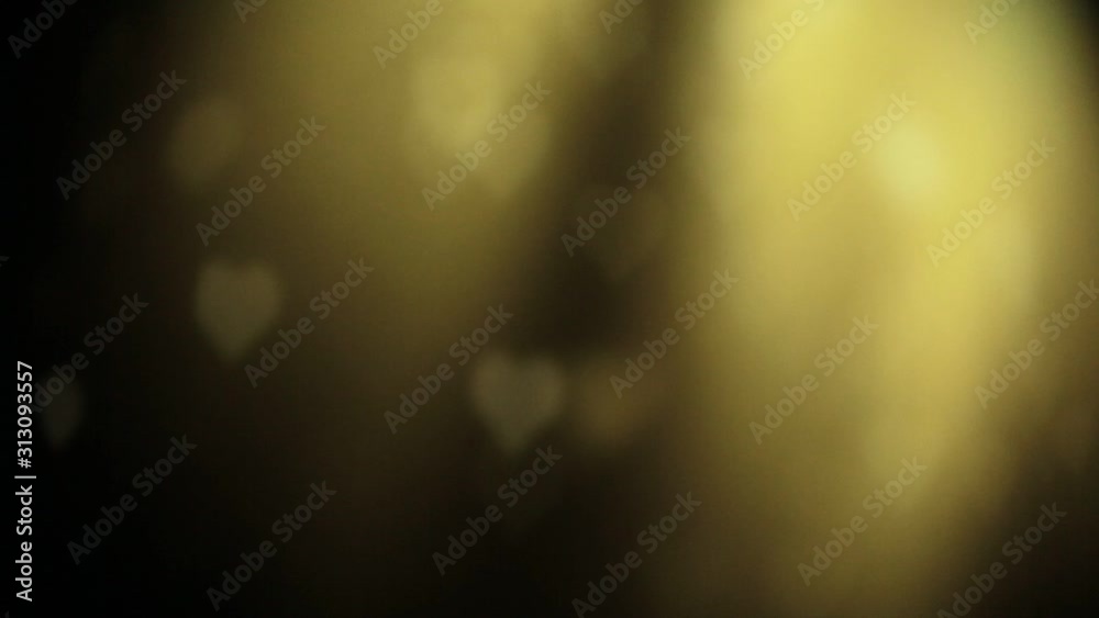 colorful heart bokeh lighting moving in dark background