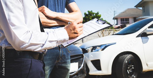 Tableau sur toile Insurance agents inspect for damage to cars that collide on the road to claim compensation from driving accidents, Insurance concept