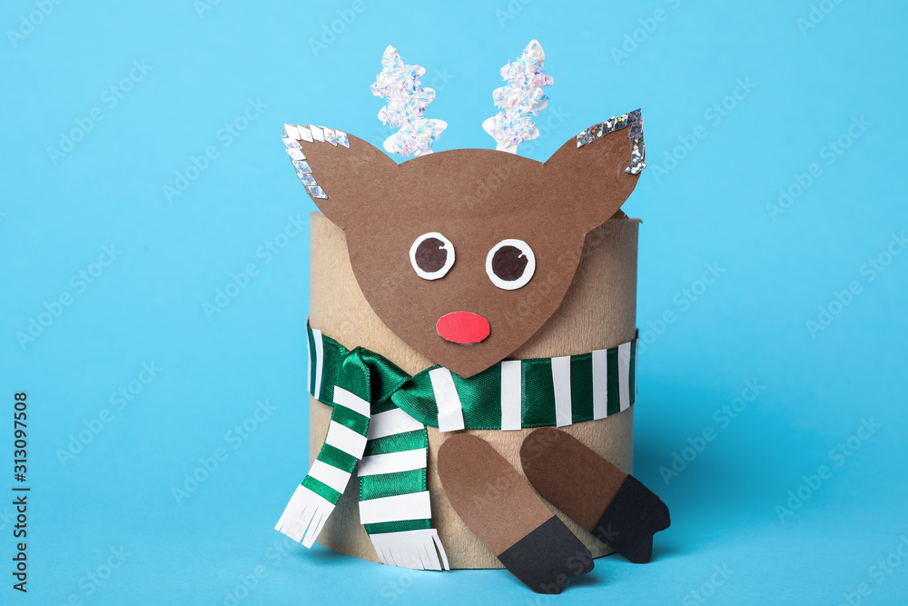 Fototapeta premium Toy deer made of toilet paper roll on light blue background