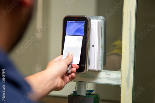 The hand are scanning on fingerprint machine for enter digital security door system in the office building at Bangkok ,Thailand. Fingerscan with access control on the glass door.