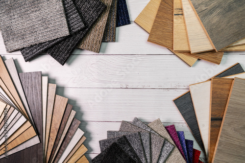 flooring and furniture materials - floor carpet and wooden laminate samples with copy space photo