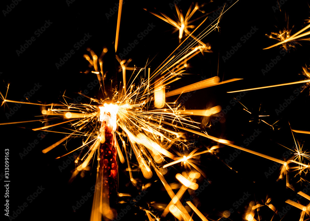 Festive party sparkler on black background Festive party sparkler on black background