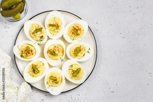 Holiday Easter one-bire snack, dill pickle deviled eggs.Top view, space for text.