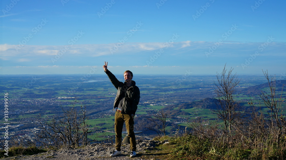 Obraz premium Tourist at the top Untersberg mountain and background with aerial panorama of Salzburg in Austria.