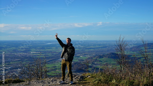 Tourist at the top Untersberg mountain and background with aerial panorama of Salzburg in Austria.