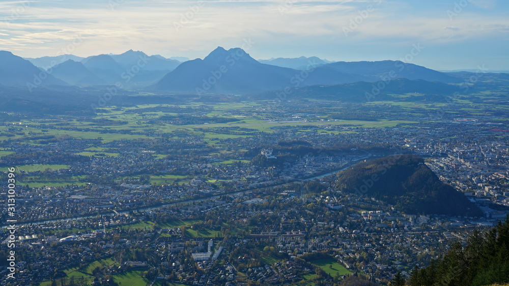 Aerial panorama of Salzburg and Alpine mountains from the top of Untersberg mountain in Austria.