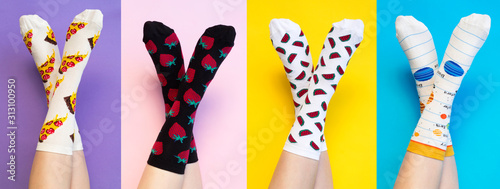Female legs in colorful socks on colored background photo