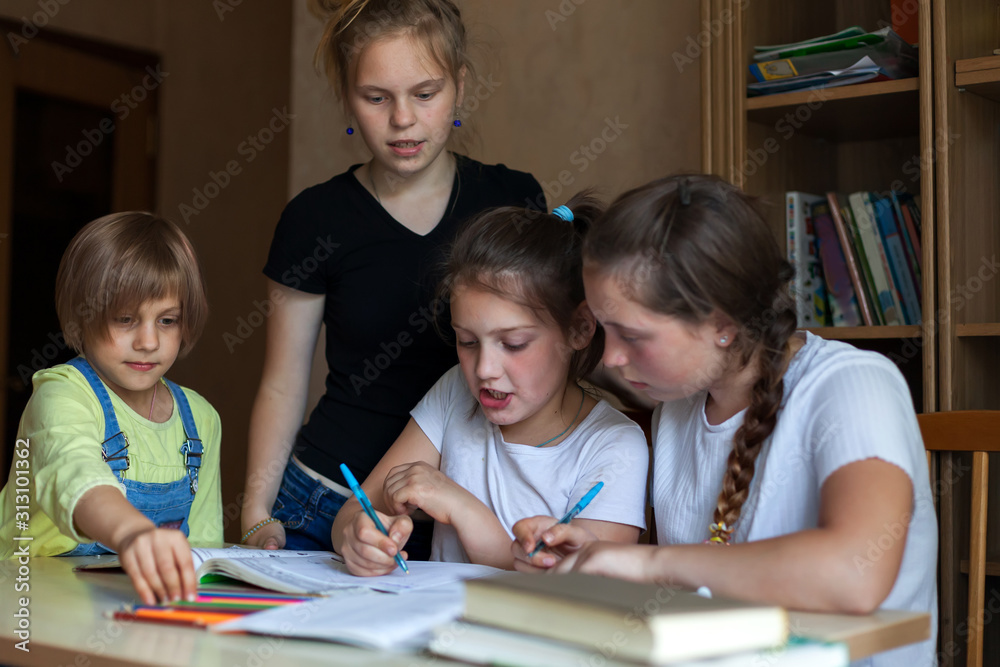 girls at   desk with notebooks and books
