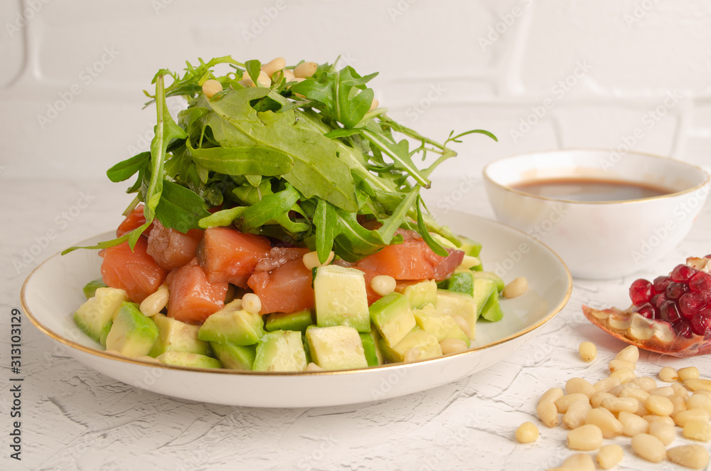 Salad of red fish, arugula, avocado. Dressed with pomegranate juice. Salad of red fish, arugula, avocado. Dressed with pomegranate juice.