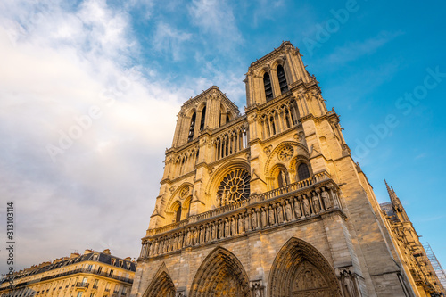 View of Notre dame cathedral and surrounding during Autumn season in the evening with clear sky . One of the most important church in the heart of Paris , France