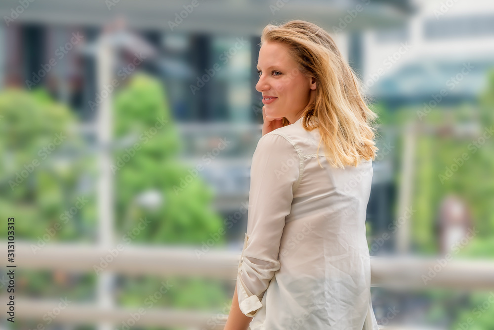 Beautiful woman standing outside office building Beautiful woman standing outside office building