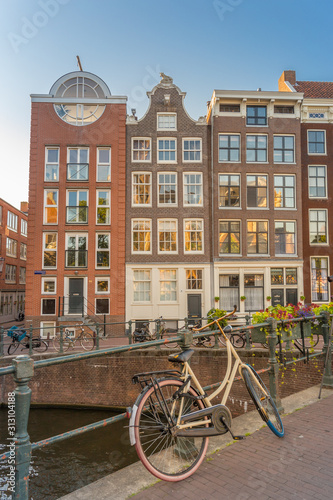 Photography A white bicycle on a bridge in Amsterdam over the Bloemgracht canal