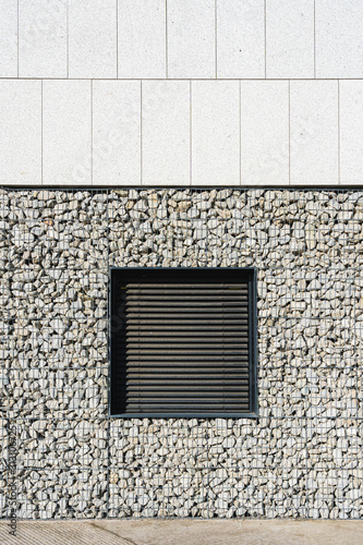 Window built on a caged stone wall photo